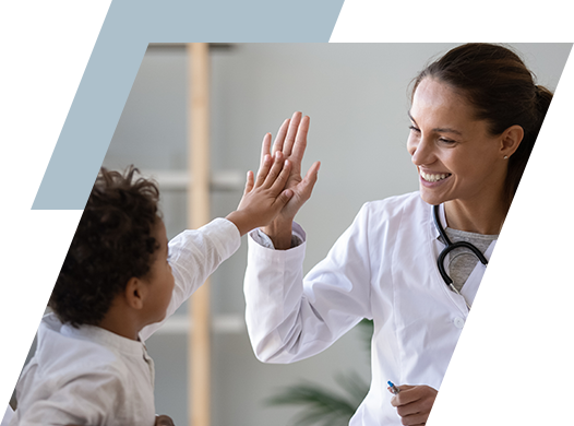 Photo of physician giving a high-five to young patient.